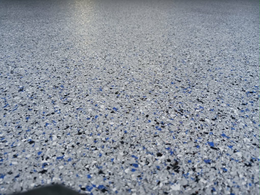Blue flake epoxy garage floor coating, close-up texture